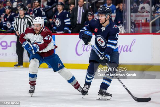 Alex Galchenyuk of the Colorado Avalanche and David Gustafsson of the Winnipeg Jets keep an eye on the play during first period action at the Canada...