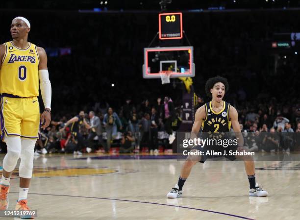 Los Angeles, CA Lakers point guard Russell Westbrook, left, watches the ball drop into the hoop as Indiana Pacers point guard Andrew Nembhard...