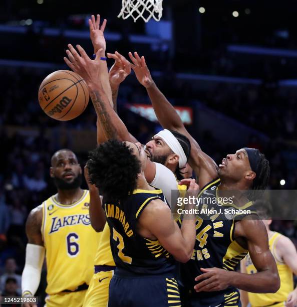 Los Angeles, CA Lakers forward Anthony Davis, #3, center, battles Indiana Pacers point guard Andrew Nembhard, left, and guard Buddy Hield, right, for...