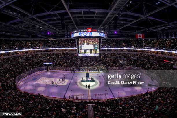 General view of the arena bowl lit up by fans during the ceremonial puck drop on Hockey Fights Cancer Night between the Winnipeg Jets and the...