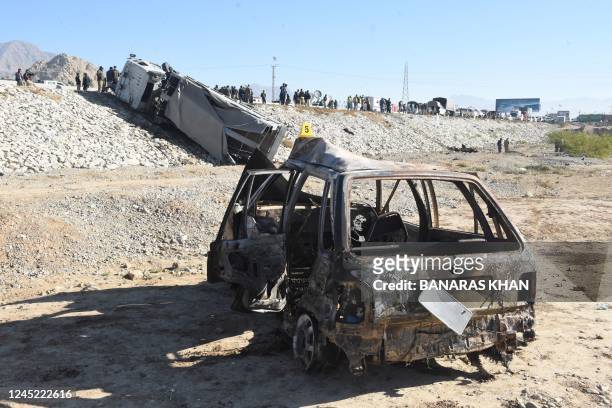 Burn vehicle is seen at the site of a suicide bomb attack targeting a police truck in Quetta on November 30, 2022. - Three people were killed and 23...