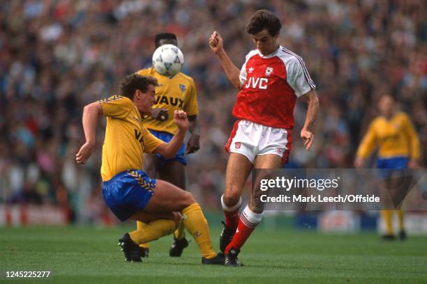 October 1990 - English Football Division One - Arsenal v Sunderland - Gordon Armstrong of Sunderland makes a tackle on Alan Smith of Arsenal. -