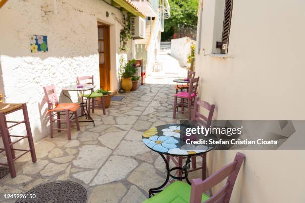 empty tables waiting for tourists in greece - plaka greek cafe stock pictures, royalty-free photos & images