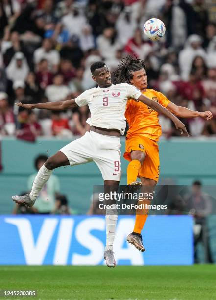 Mohammed Muntari of Qatar and Luuk de Jong of Netherlands battle for the ball during the FIFA World Cup Qatar 2022 Group A match between Netherlands...