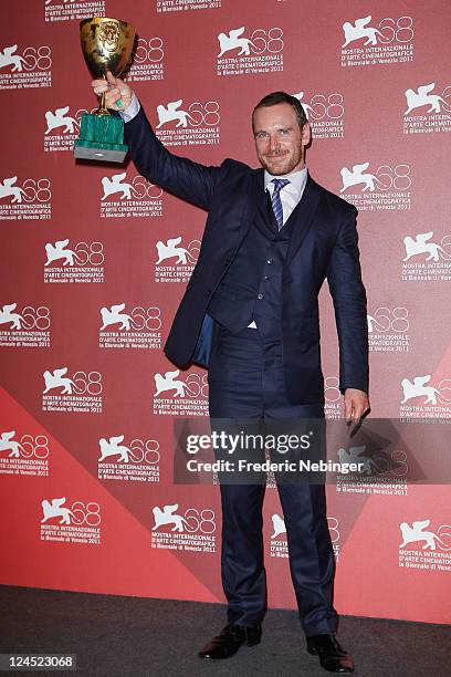 Actor Michael Fassbender of "Shame" poses with the Coppa Volpi for Best Actor during the Award Winners Photocall during the 68th Venice Film Festival...