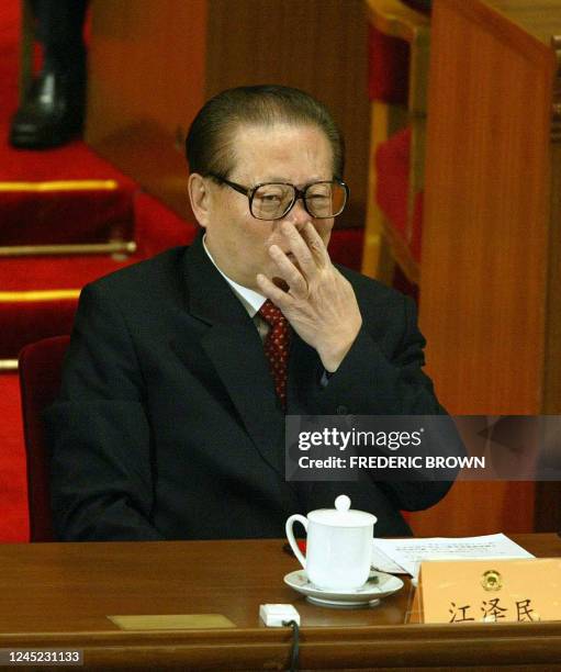 Chinese President Jiang Zemin gestures during the closing session of the Chinese People's Political Consultative Conference , the nominal lower...