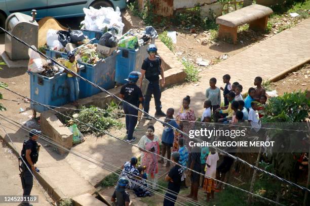 Police officers of the GAO unit enters a slum on November 28, 2022 in the village of Vahibe, near Mamoudzou, in the French Indian Ocean territory of...