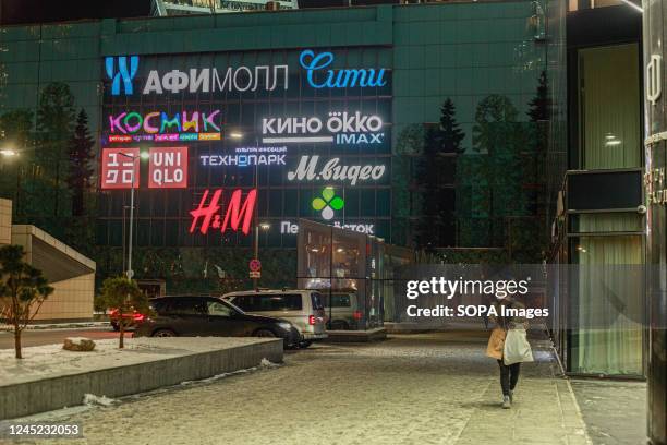 Logos of H&M and Uniqlo, amongst others, seen on the facade of the Afimall City shopping center in Moscow.