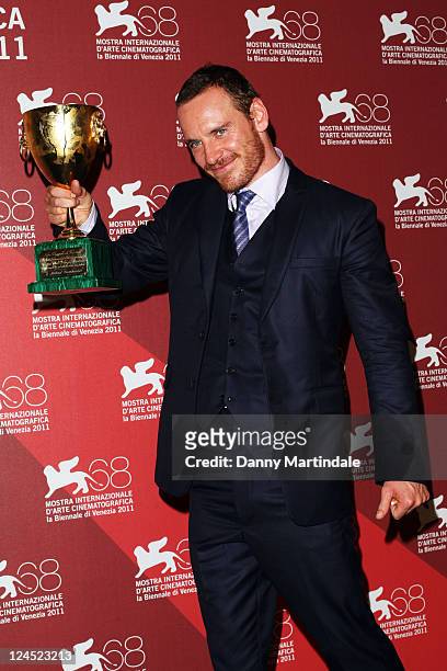 Actor Michael Fassbender of "Shame" poses with the Coppa Volpi for Best Actor during the Award Winners" Photocall during the 68th Venice...