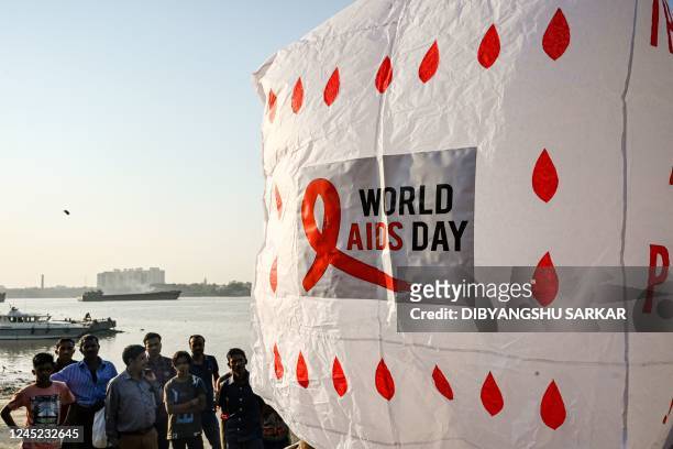 Social activists prepare to release a traditional hot air balloon to create awareness about HIV AIDS on the eve of World AIDS Day in Kolkata on...