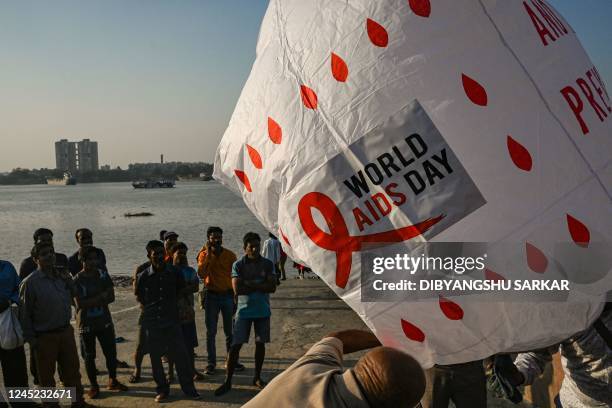 Social activists prepare to release a traditional hot air balloon to create awareness about HIV AIDS on the eve of World AIDS Day in Kolkata on...