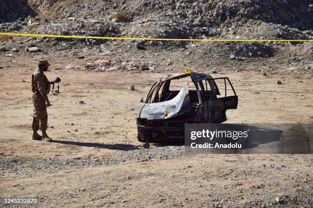 Security personnel examine a damaged car, when a suspected suicide bomber blew himself up near a police vehicle in Quetta, Pakistan on November 30,...