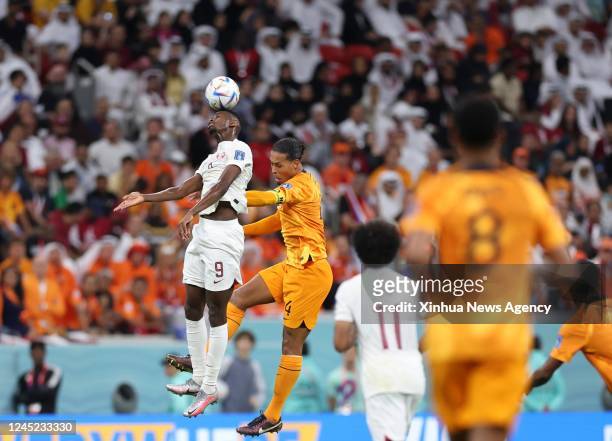 Mohammed Muntari L of Qatar heads the ball during the Group A match between the Netherlands and Qatar at the 2022 FIFA World Cup at Al Bayt Stadium...