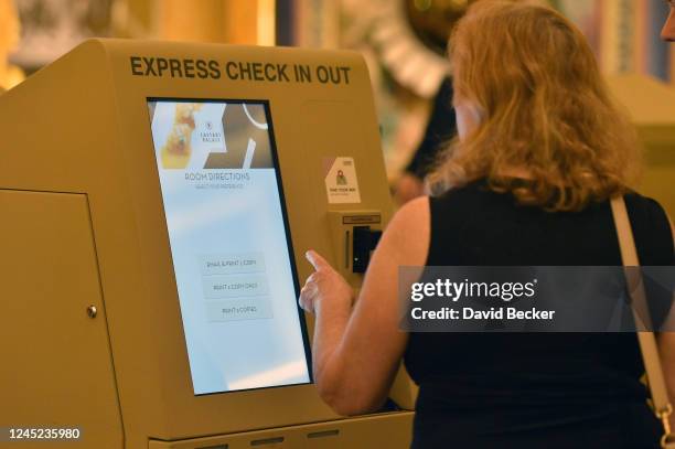 Hotel guest uses self-guided check-in kiosk at Caesars Palace on the Las Vegas Strip as the property opens for the first time since being closed on...