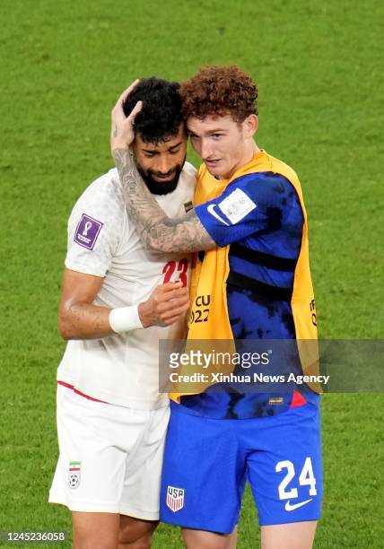 Josh Sargent R of the United States consoles Ramin Rezaeian of Iran after the Group B match between Iran and the United States at the 2022 FIFA World...