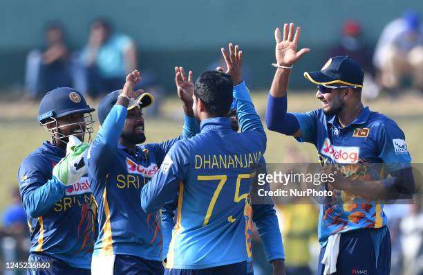 Sri Lankan players celebrate with their teammates after taking the wicket of Afghanistan during the final one-day international cricket match between...