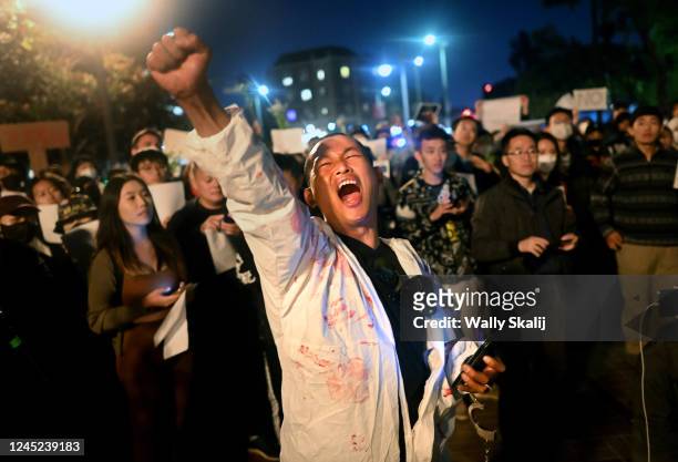 Los Angeles, California November 29, 2022-Lijian Jie yells in protest during a candlelight vigil for victims who suffer under Chinas stringent...
