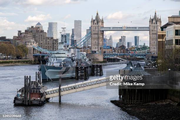 View of barges, Thames Clipper ferry terminal and boats on the River Thames looking towards Tower Bridge on 17th November 2022 in London, United...