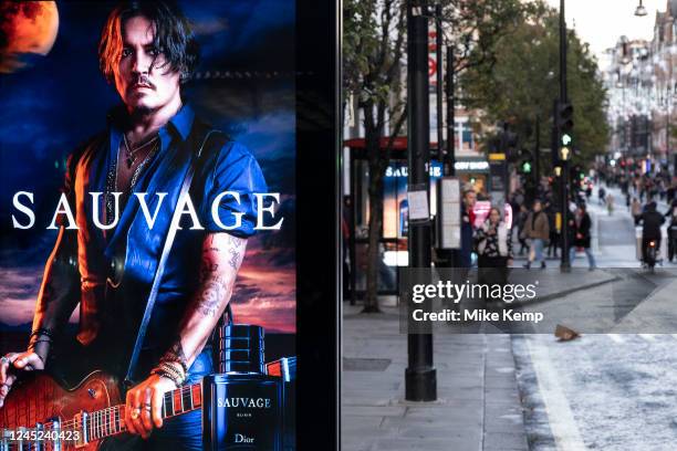 Advertising for the Dior mens fragrance Sauvage featuring American actor and film star Johnny Depp on a bus stop on Oxford Street as it is announced...