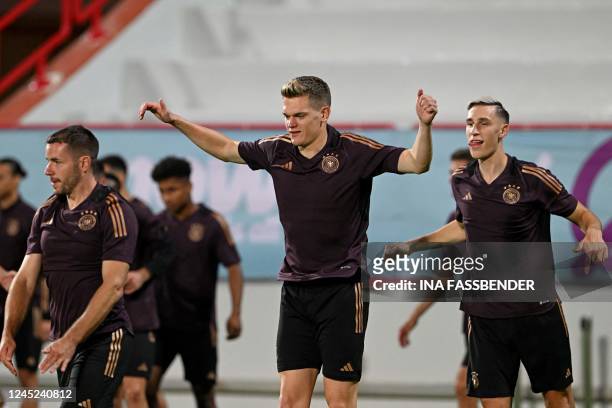 Germany's defender Christian Gunter, Germany's defender Matthias Ginter and Germany's defender Nico Schlotterbeck take part in a training session at...