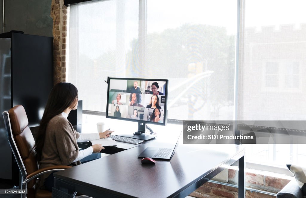 Woman meets with colleagues virtually