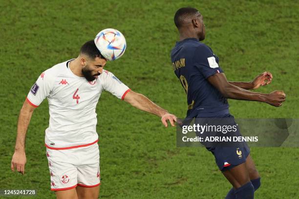 Tunisia's defender Yassine Meriah and France's forward Randal Kolo Muani jump for a header during the Qatar 2022 World Cup Group D football match...