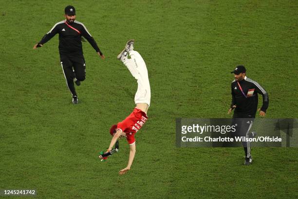 A pitch invader performing gymnastics during the FIFA World Cup Qatar 2022 Group D match between Tunisia and France at Education City Stadium on...