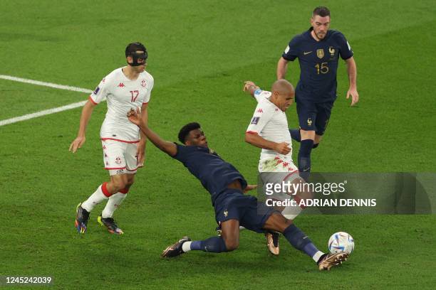 France's midfielder Aurelien Tchouameni challenged Tunisia's forward Wahbi Khazri during the Qatar 2022 World Cup Group D football match between...