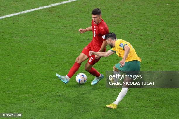 Australia's forward Mathew Leckie shoots to score his team's first goal during the Qatar 2022 World Cup Group D football match between Australia and...