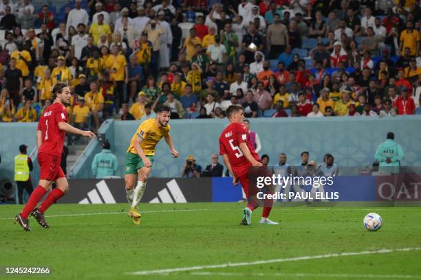 Australia's forward Mathew Leckie scores his team's first goal during the Qatar 2022 World Cup Group D football match between Australia and Denmark...