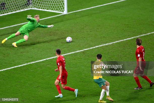 Australia's forward Mathew Leckie scores his team's first goal past Denmark's goalkeeper Kasper Schmeichel during the Qatar 2022 World Cup Group D...