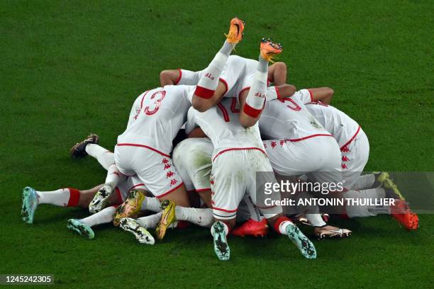 Tunisia's forward Wahbi Khazri celebrates with teammates after scoring his team's first goal during the Qatar 2022 World Cup Group D football match...