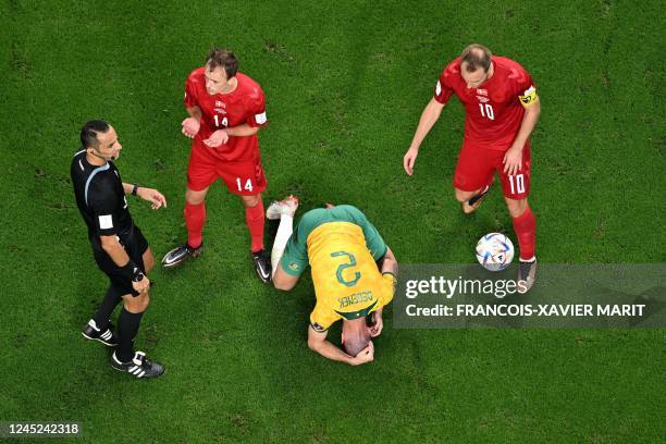 Australia's defender Milos Degenek reacts on the pitch as Denmark's midfielder Mikkel Damsgaard and Denmark's midfielder Christian Eriksen argue with...