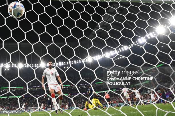 Tunisia's forward Wahbi Khazri celebrates with teammate midfielder Mohamed Ali Ben Romdhane after scoring his team's first goal past France's...