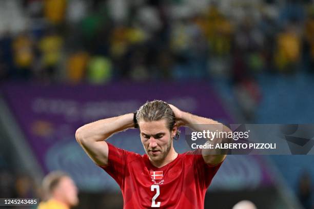 Denmark's defender Joachim Andersen reacts after losing the Qatar 2022 World Cup Group D football match between Australia and Denmark at the...