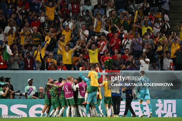 Australia's forward Mathew Leckie celebrates with teammates after he scored his team's first goal during the Qatar 2022 World Cup Group D football...