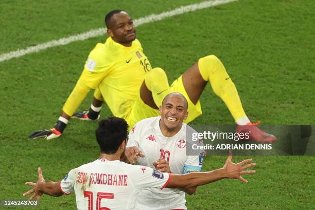Tunisia's forward Wahbi Khazri celebrates with Tunisia's midfielder Mohamed Ali Ben Romdhane after scoring his team's first goal past France's...