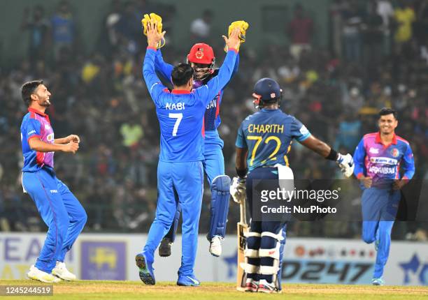 Afghanistan's Mohammad Nabi celebrates with their teammates after taking the wicket of Sri Lanka during final one-day international cricket match...