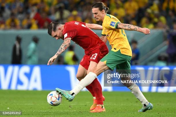 Denmark's midfielder Pierre-Emile Hojbjerg and Australia's midfielder Jackson Irvine fight for the ball during the Qatar 2022 World Cup Group D...