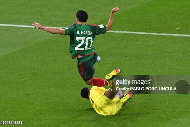 Saudi Arabia's goalkeeper Mohammed Al-Owais denies Mexico's forward Henry Martin from scoring during the Qatar 2022 World Cup Group C football match...