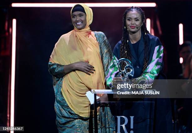 Somali-born Fartuun Adan and her daughter Ilwad Elman, founders of Elman Peace Somalia, stand on stage after having been presented with the 2022...
