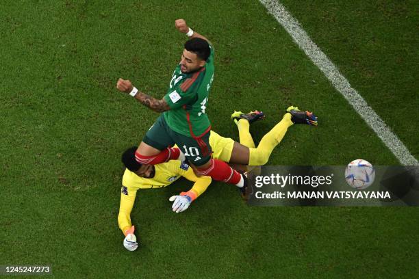 Mexico's forward Alexis Vega and Saudi Arabia's goalkeeper Mohammed Al-Owais fight for the ball during the Qatar 2022 World Cup Group C football...