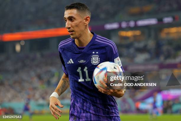 Argentina's midfielder Angel Di Maria holds the ball after he missed chance during the Qatar 2022 World Cup Group C football match between Poland and...