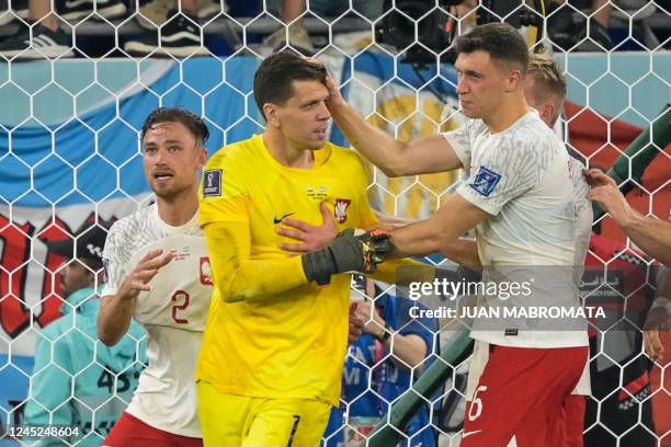 Poland's goalkeeper Wojciech Szczesny celebrates with teammates after he saved a penalty shot during the Qatar 2022 World Cup Group C football match...