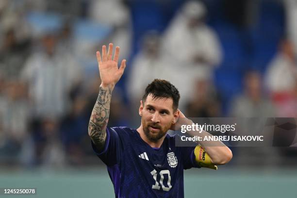 Argentina's forward Lionel Messi waves to supporters after his team won the Qatar 2022 World Cup Group C football match between Poland and Argentina...