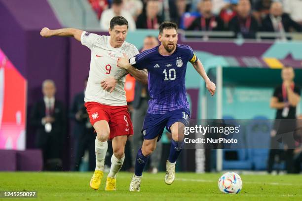 Robert Lewandowski centre-forward of Poland and FC Barcelona and Lionel Messi right winger of Argentina and Paris Saint-Germain compete for the ball...