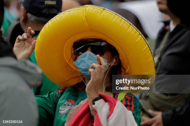 Attendees at the FIFA Fan Fest Mexico on the esplanade of the Monumento a la Revolución in Mexico City, on the occasion of the match between the...