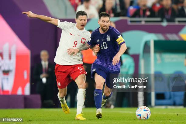 Robert Lewandowski centre-forward of Poland and FC Barcelona and Lionel Messi right winger of Argentina and Paris Saint-Germain compete for the ball...
