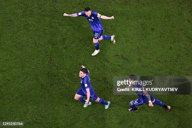 Argentina's forward Julian Alvarez celebrates with Argentina's forward Lionel Messi and Argentina's midfielder Enzo Fernandez after scoring his...