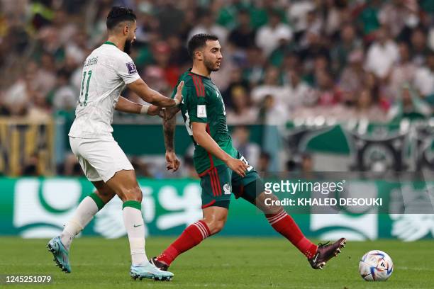 Mexico's midfielder Luis Chavez is challenged by Saudi Arabia's forward Saleh Al-Shehri during the Qatar 2022 World Cup Group C football match...